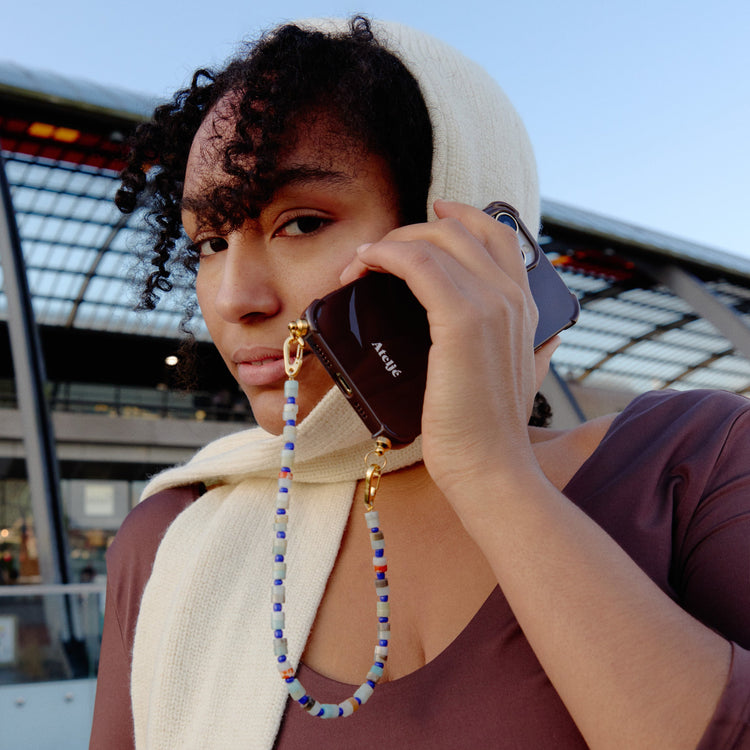 Dark brown recycled iPhone case with True blue cord